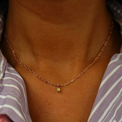 Close up view of a model's neck wearing a rose gold Yellow Diamond Charm on a Butch Chain