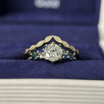 14k Champagne Gold & 6mm Round Lab Diamond & 2pc 2.7mm Customer’s Sapphires & 4pc Tiny Teal/Blue Sapphires Custom Ring & 14k Champagne Gold Nesting Leaves Custom Band