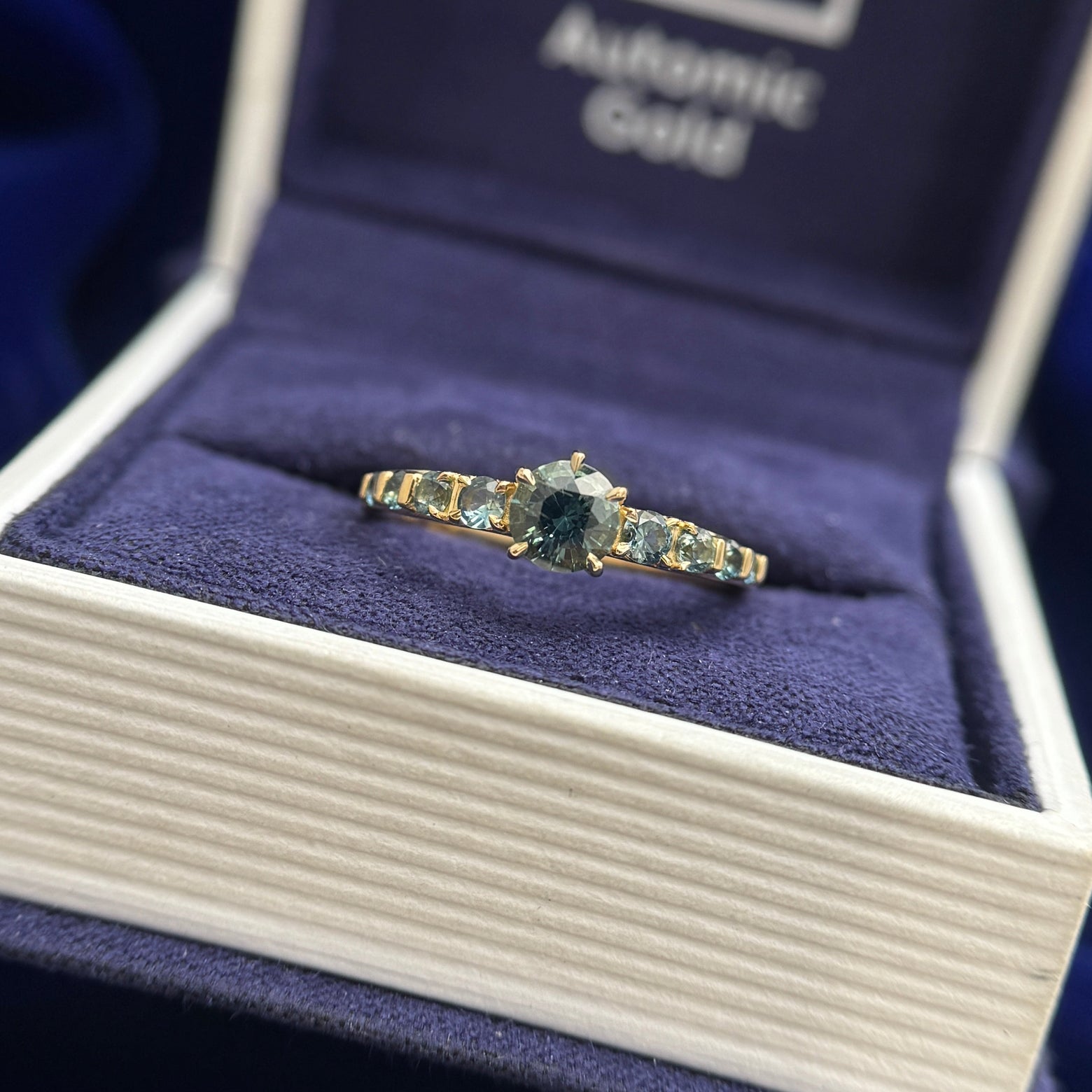 18k Yellow Gold Bead-prongs-set 5x2mm Round Teal Sapphires on 4mm Mix Mirror Band Custom Ring, size 10 and 18k Yellow Gold and 4mm Round Teal Sapphire with 8pc Graduating is size Teal Sapphires on Custom Ring, size 6