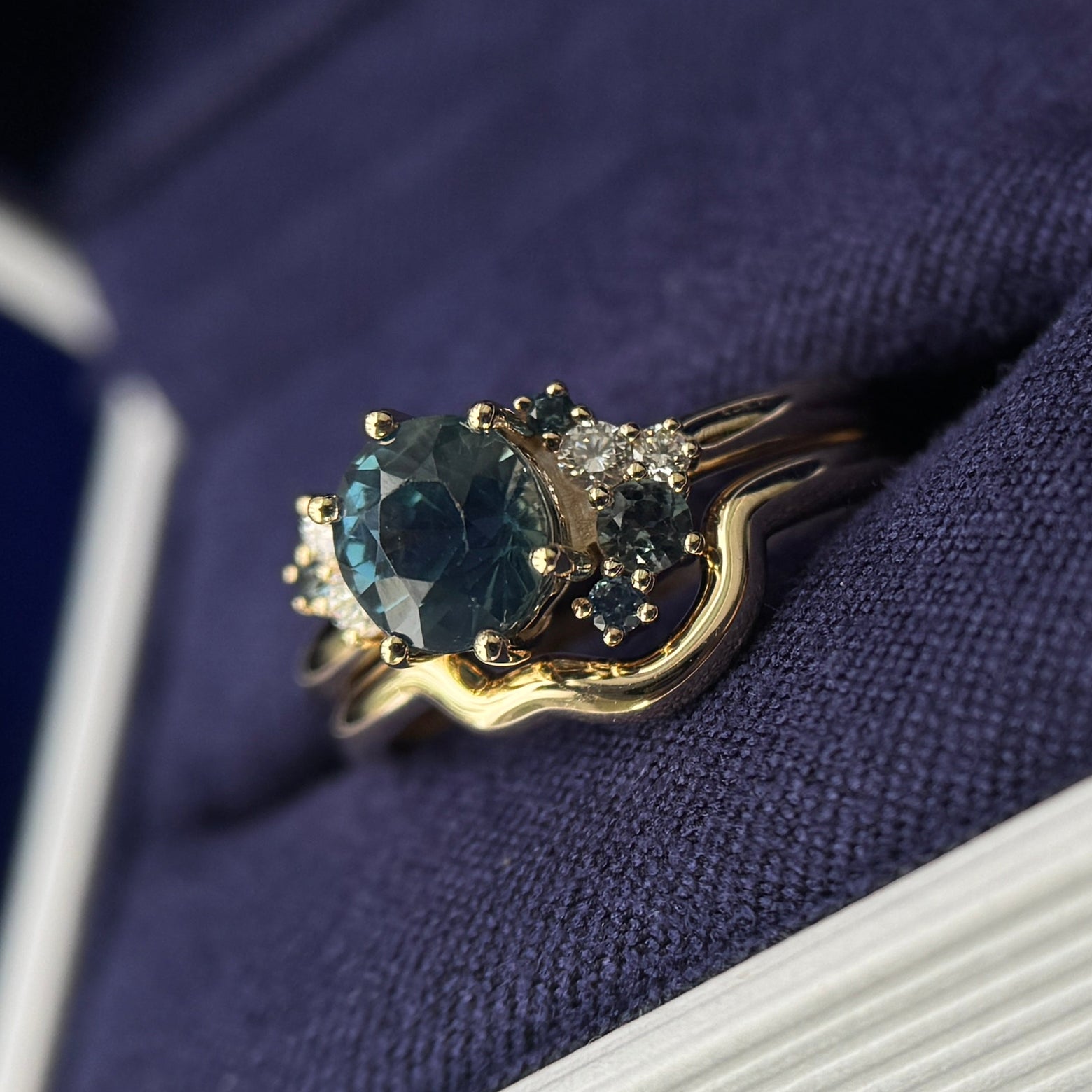 14k Yellow Gold with 1.5ct 6.2mm Sapphire with Cluster of Teal Sapphires and Diamonds Custom Ring and thin Custom Nesting Band, both in size 5.75