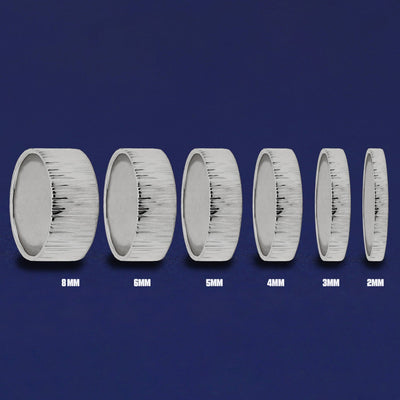 Seven versions of the Silver Industrial Wood Band showing the different thickness options of the ring from 8mm to 2mm