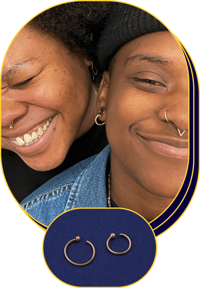 Two smiling models wearing different Automic Gold septum rings and nose rings; Inset of two Nose Rings on a blue background
