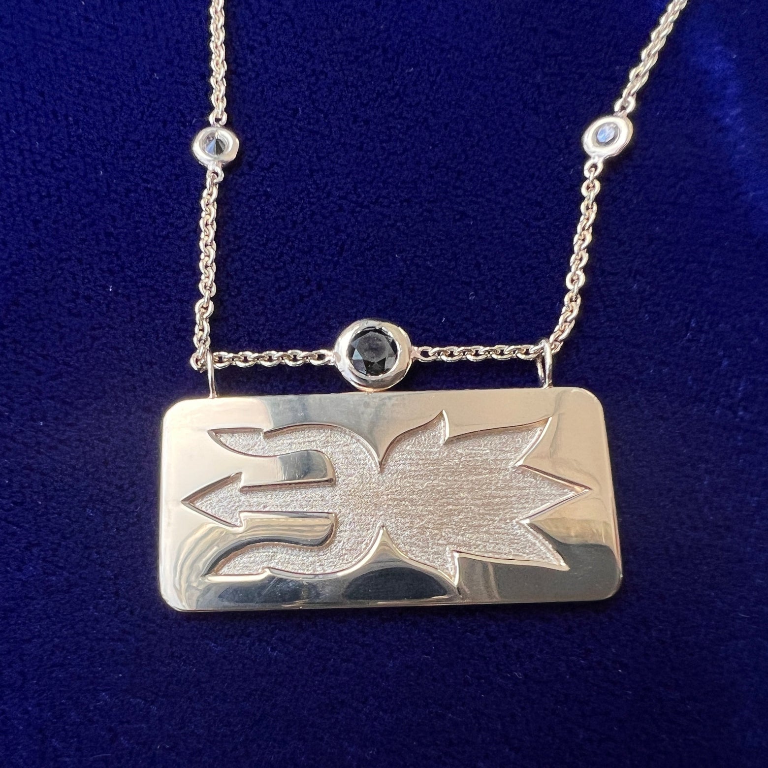 close up of necklace in with solid matching pendant
