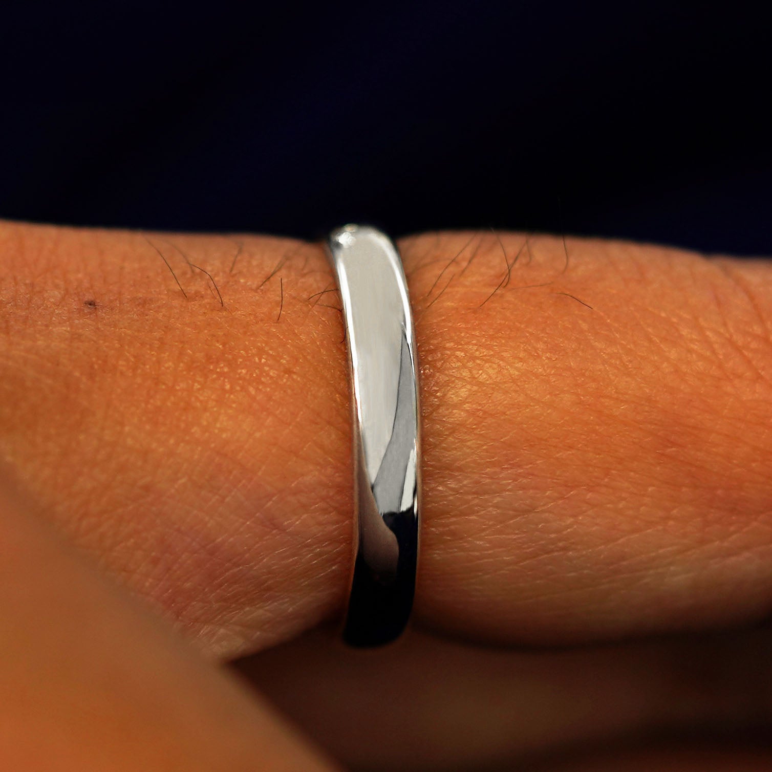 Side view of a solid Silver Mix Mirror Band on a model's finger
