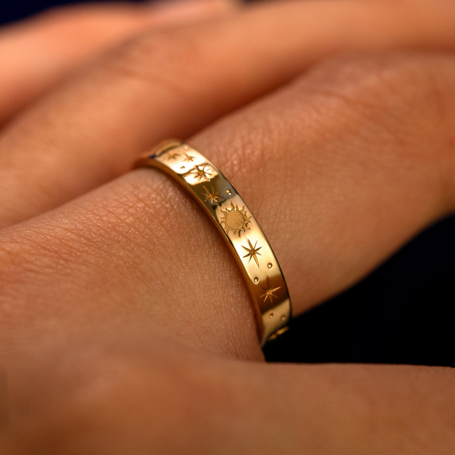 Side view of a Industrial Sun Moon and Stars Band on a model's finger