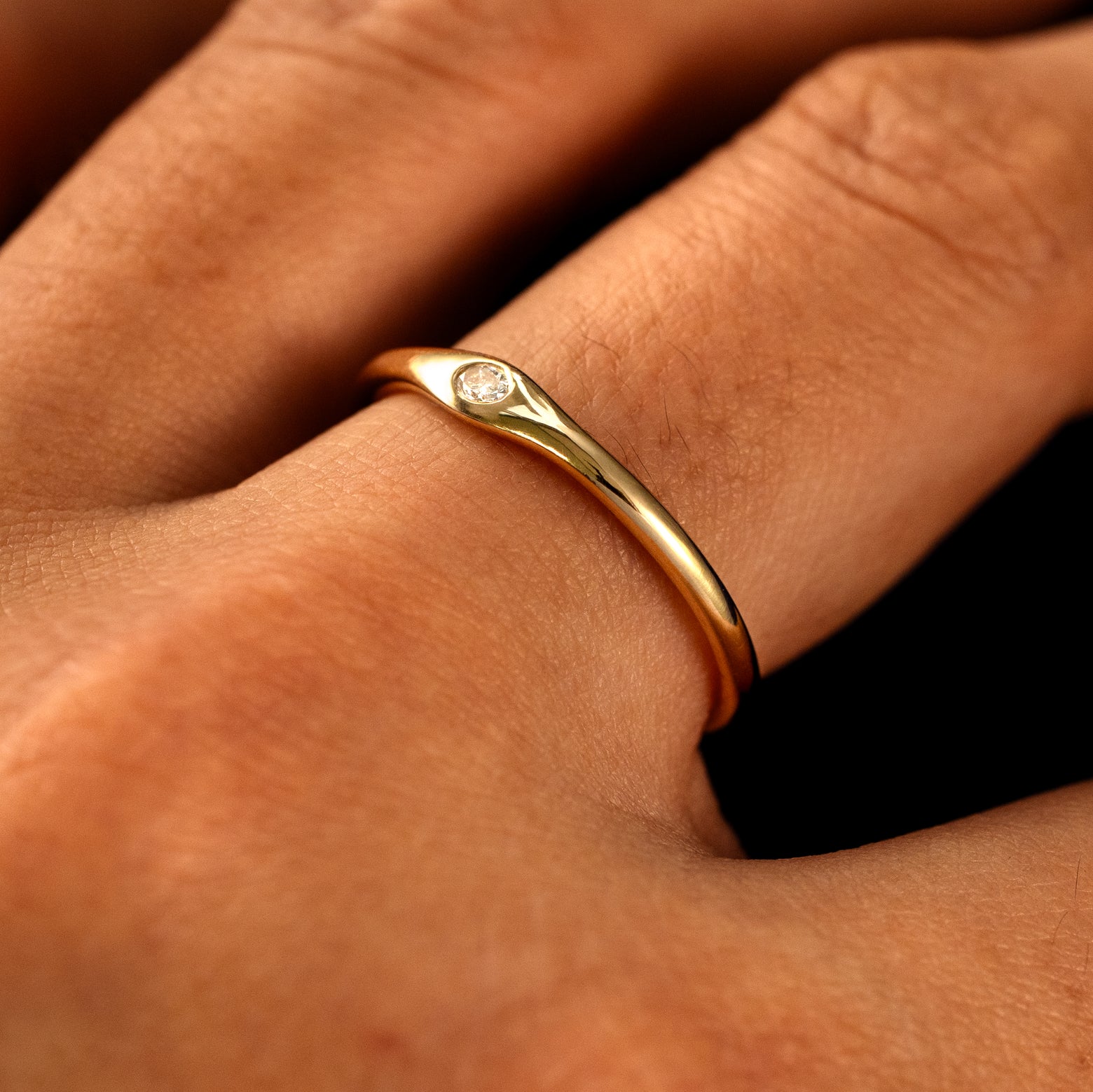 Side view of a Flush Set Oval Diamond Ring on a model's finger