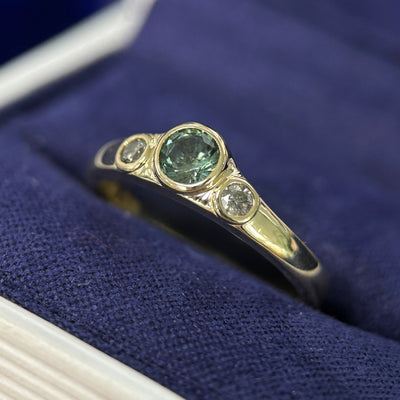 14k Yellow Gold & Bezel-low-set 0.45ct Round Teal Sapphire & 2.5mm Salt-and-pepper Diamonds on Tapered One-side-flat Band 3-stone Custom Ring