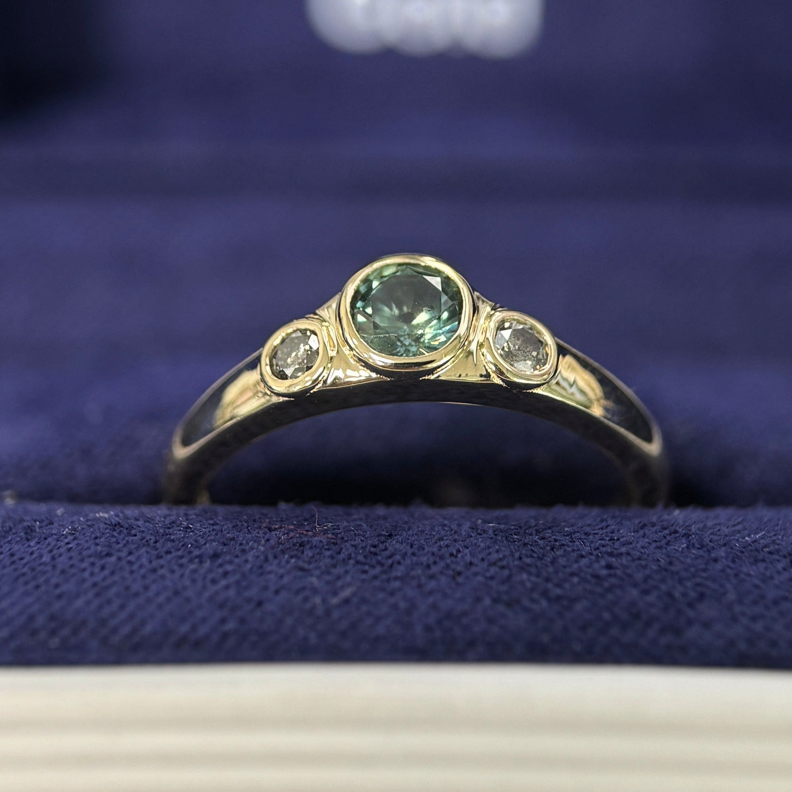 14k Yellow Gold & Bezel-low-set 0.45ct Round Teal Sapphire & 2.5mm Salt-and-pepper Diamonds on Tapered One-side-flat Band 3-stone Custom Ring