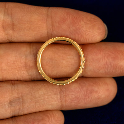 A Thin Filigree Band lying flat in a models hand to show the thickness of the Ring
