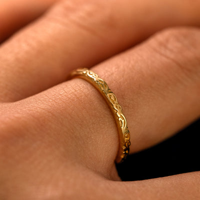 Side view of a Thin Filigree Band on a model's finger