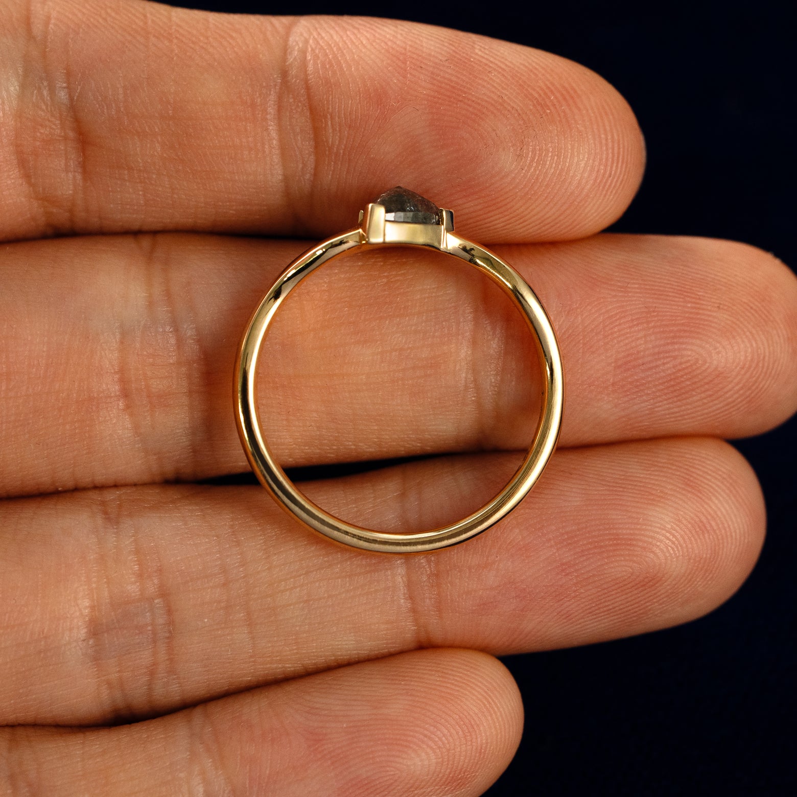 A Trillion Salt and Pepper Diamond Wavy Ring in a model's hand showing the thickness of the band