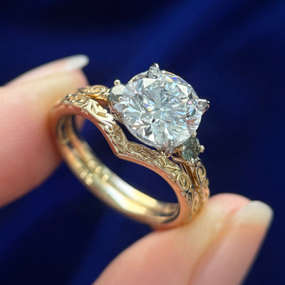 950 Platinum Vintage-style Prongs 2ct Round Lab Diamond with 14k Yellow Gold set 2pc 2.6mm Green Sapphires on 2mm Filigree three quarters around Band Custom Ring and 14k Yellow Gold 2mm Chevron Nesting Filigree three quarters around Band Custom Ring, both in size 5.5