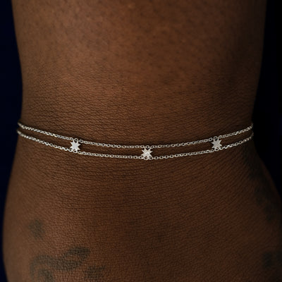 A model wearing a white gold 8 pointed star bracelet