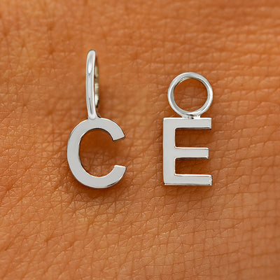 Two versions of the Block Initial Charm in the letters C and E showing For Chain and For Earring options in white gold