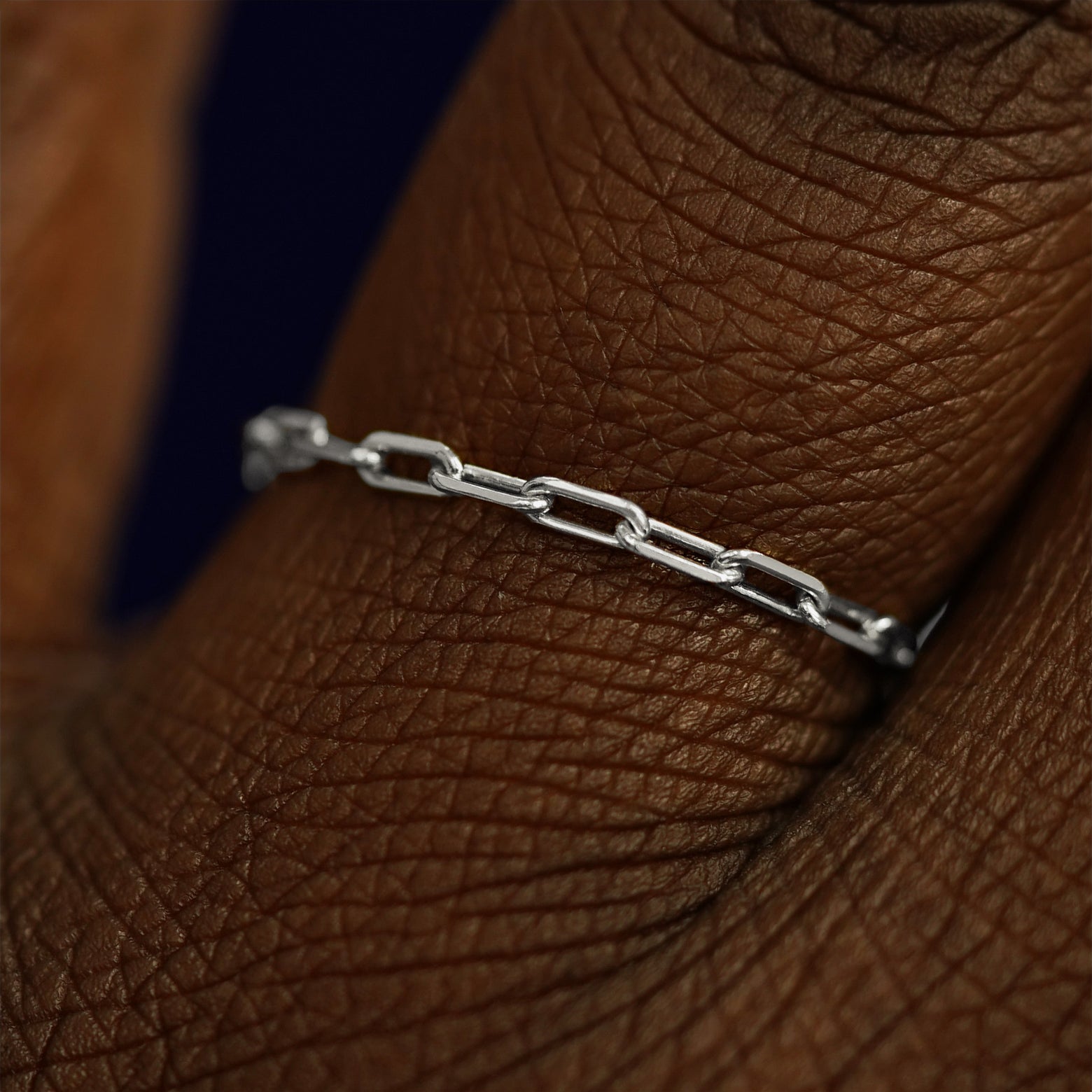 Close up view of a model's fingers wearing a 14k white gold Butch Chain Ring