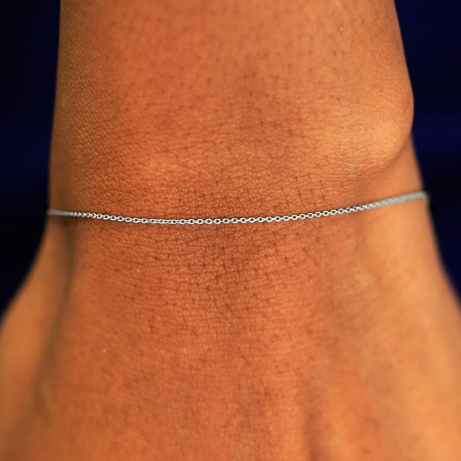 A model's wrist wearing a solid 14k white gold Cable Bracelet