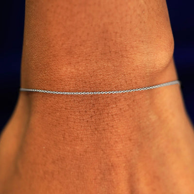 A model's wrist wearing a solid 14k white gold Cable Bracelet