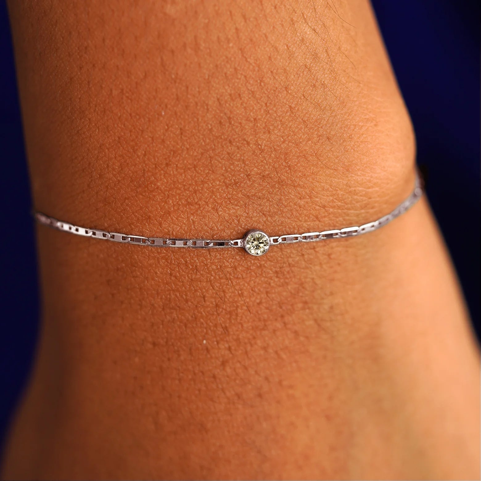 A model's wrist wearing a 14 karat white gold Champagne Diamond Bracelet