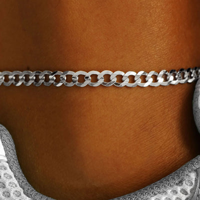 Close up view of a model's ankle wearing a 14k white gold Curb Anklet
