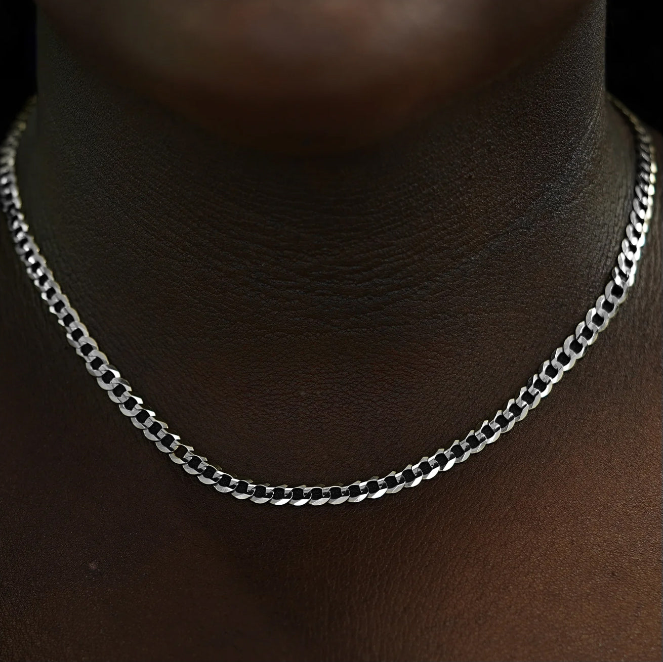 Close up view of a model's neck wearing a solid 14k white gold Curb Chain