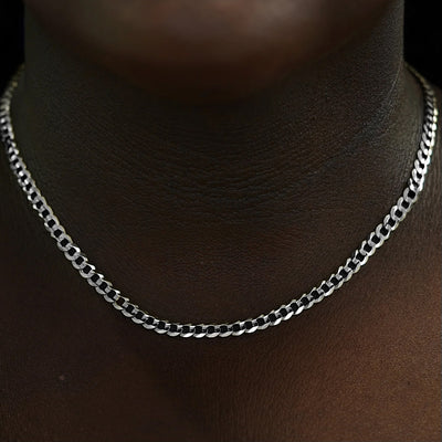 Close up view of a model's neck wearing a solid 14k white gold Curb Chain