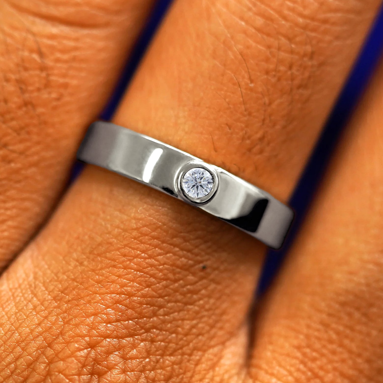 Close up view of a model's fingers wearing a 14k white gold Diamond Industrial Band