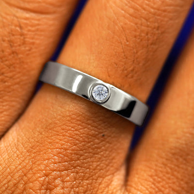 Close up view of a model's fingers wearing a 14k white gold Diamond Industrial Band