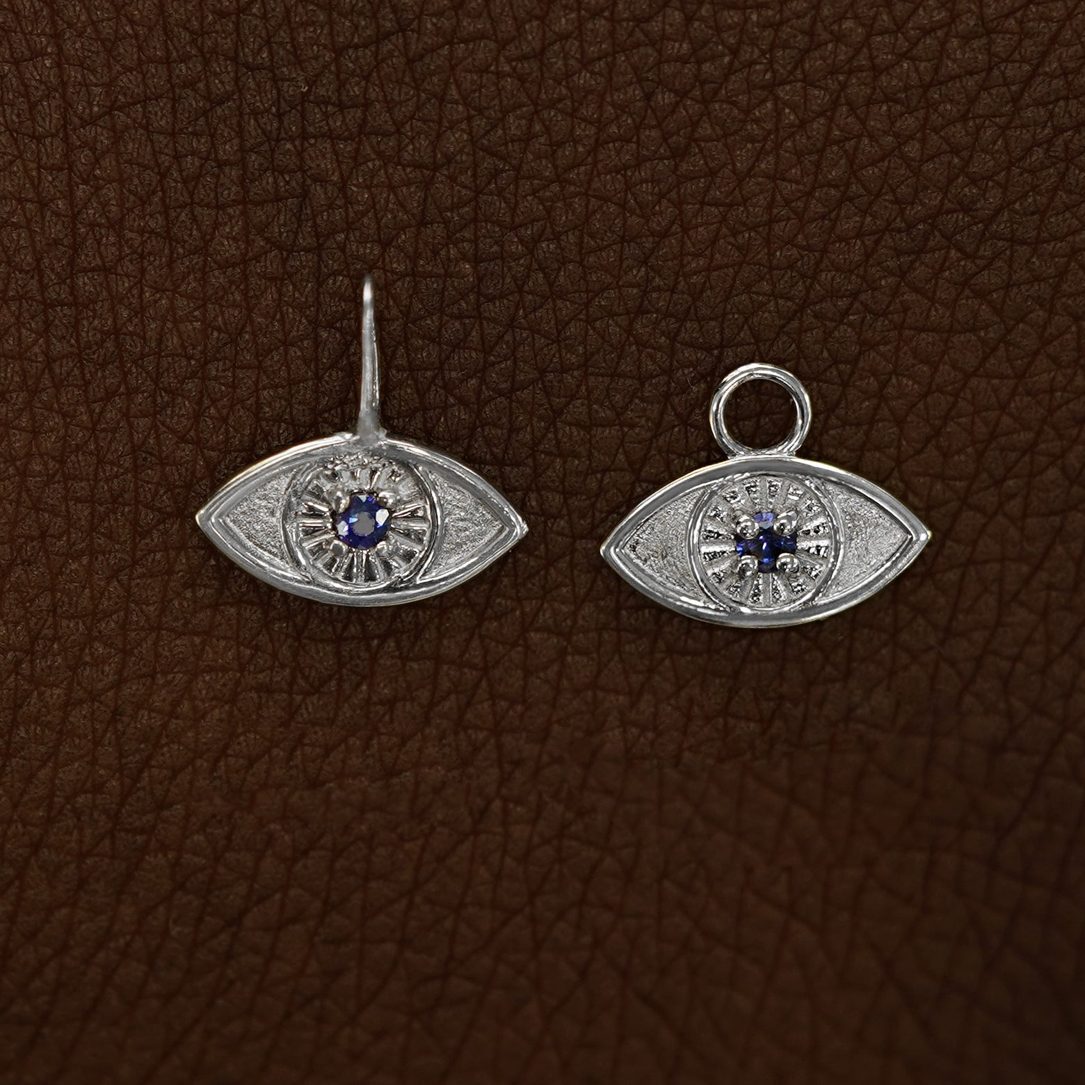 Two 14 karat White gold blue sapphire Evil Eye Charms shown in the For Chain and For Earring options