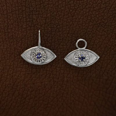 Two 14 karat White gold blue sapphire Evil Eye Charms shown in the For Chain and For Earring options