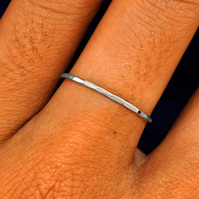 Close up view of a model's fingers wearing a 14k white gold Hammered Ring