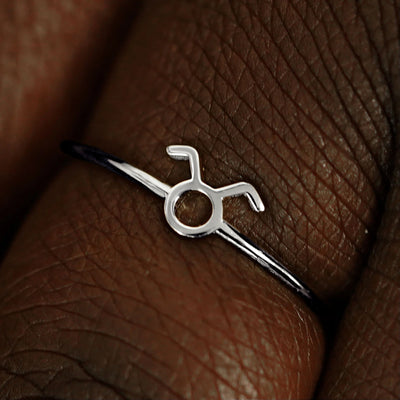 Close up view of a model's fingers wearing a 14k white gold Taurus Horoscope Ring