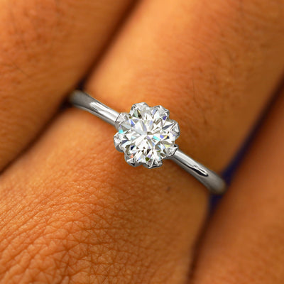 Close up view of a model's hand wearing a solid white gold Lab Diamond Petal Ring