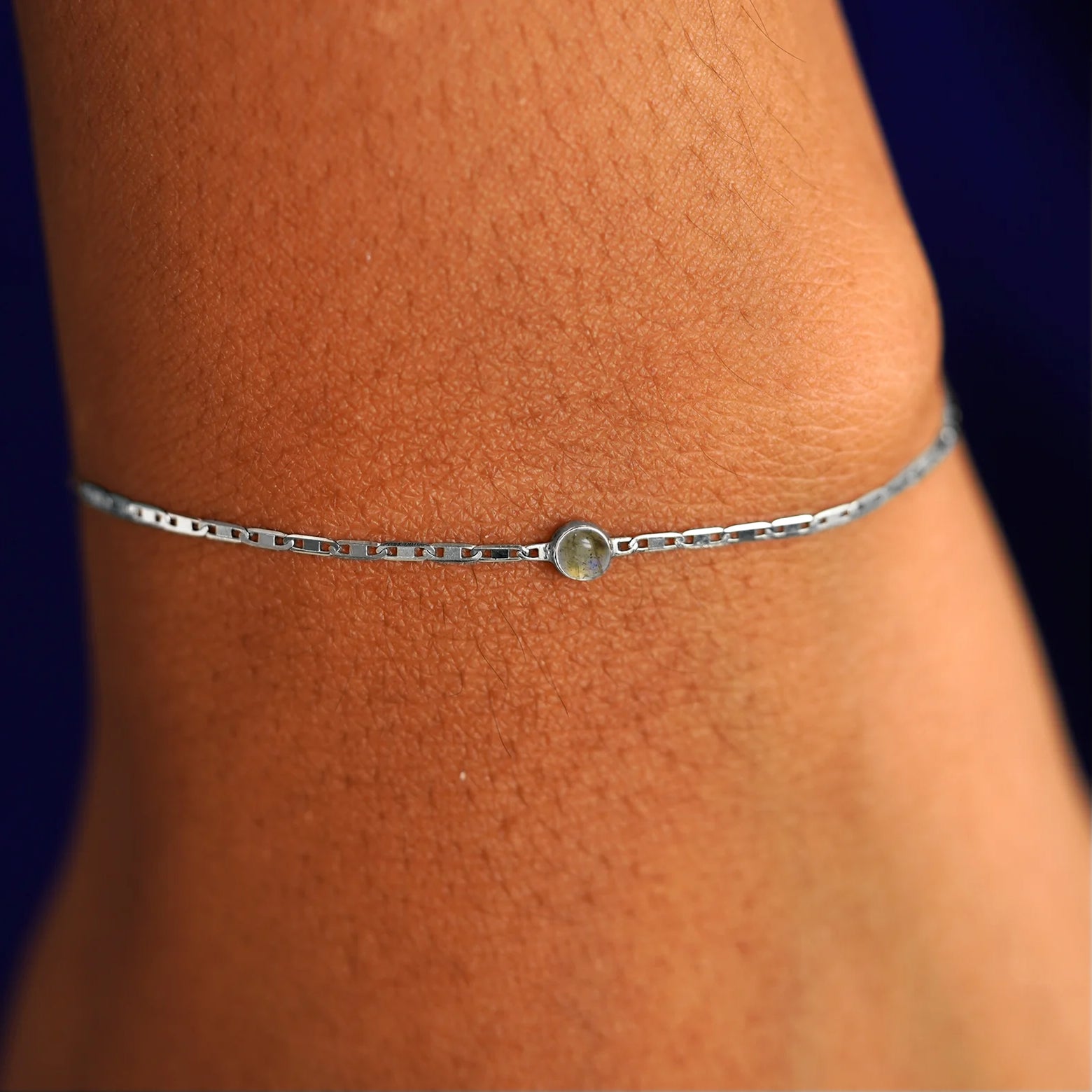 Close up view of a models wrist wearing 14k white gold Labradorite Bracelet