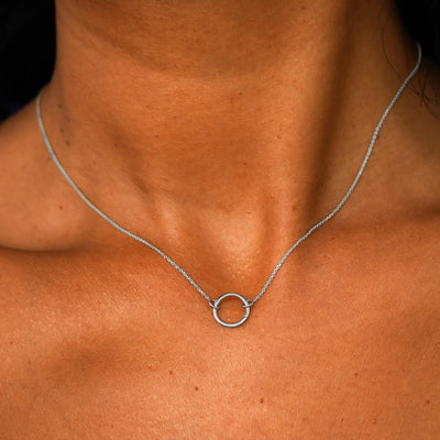 Close up view of a model's neck wearing a solid 14k white gold Lockless Cable Necklace