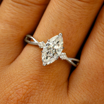 A solid 14k white gold Marquise Lab Diamond Three Stone Ring on a model's finger
