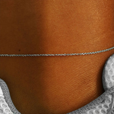 Close up view of a model's ankle wearing a solid 14k white gold Medium Cable Chain