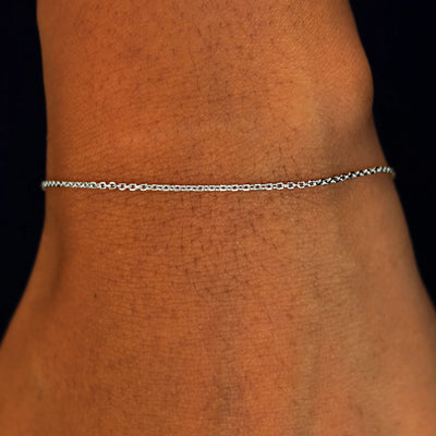 Close up view of a model's wrist wearing a solid 14k white gold Medium Cable Chain