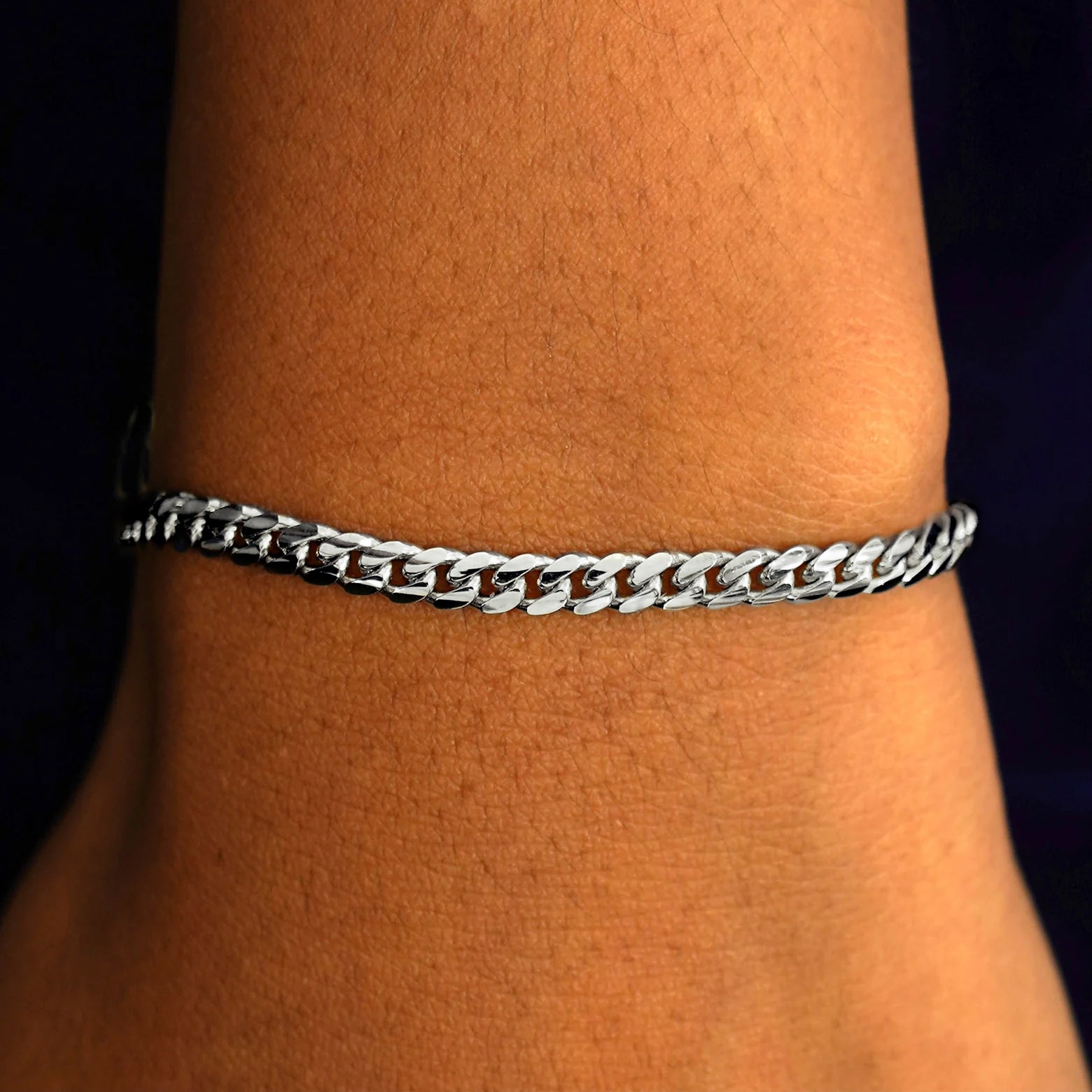 A model's wrist wearing a 14k solid white gold Medium Miami Bracelet