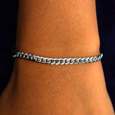 A model's wrist wearing a 14k solid white gold Medium Miami Bracelet