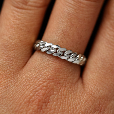 Close up view of a model's fingers wearing a 14k white gold Medium Miami Ring