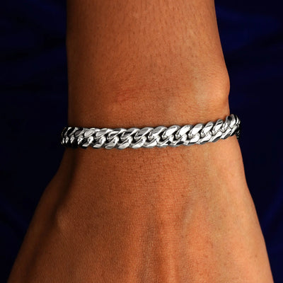 A model's wrist wearing a solid 14k white gold Miami Cuban Bracelet