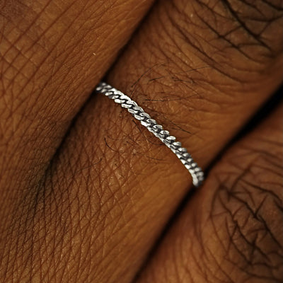 Close up view of a model's fingers wearing a 14k white gold Mini Miami Ring
