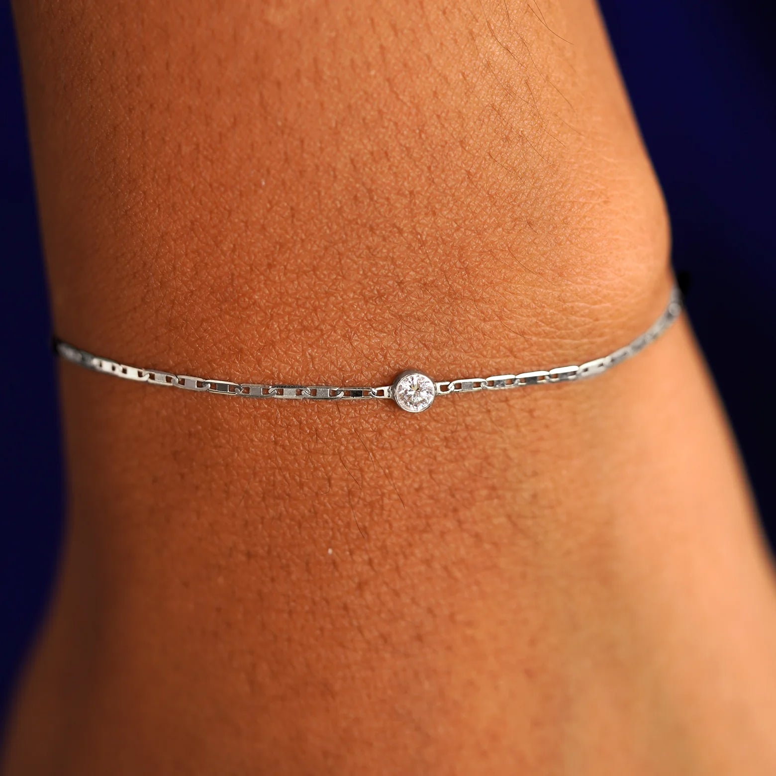 A model's wrist wearing a 14 karat white gold Moissanite Bracelet