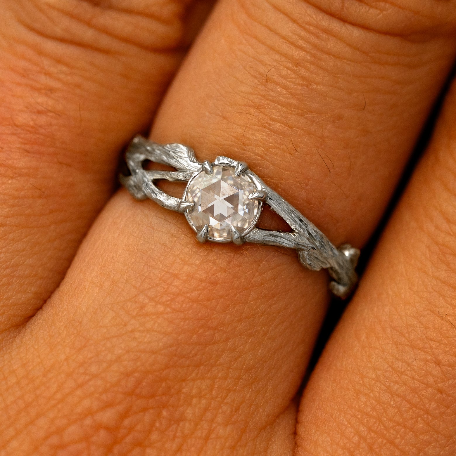 Close up view of a model's fingers wearing a 14k white gold Moissanite Branches Ring