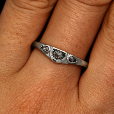 A model's hand wearing a 14k white gold Moon Cut Salt and Pepper Diamond Ring