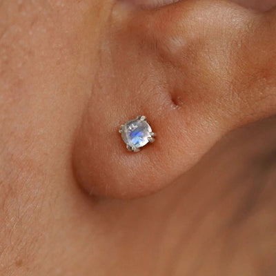 Close up view of a model's ear wearing a 14k white gold Moonstone Earring