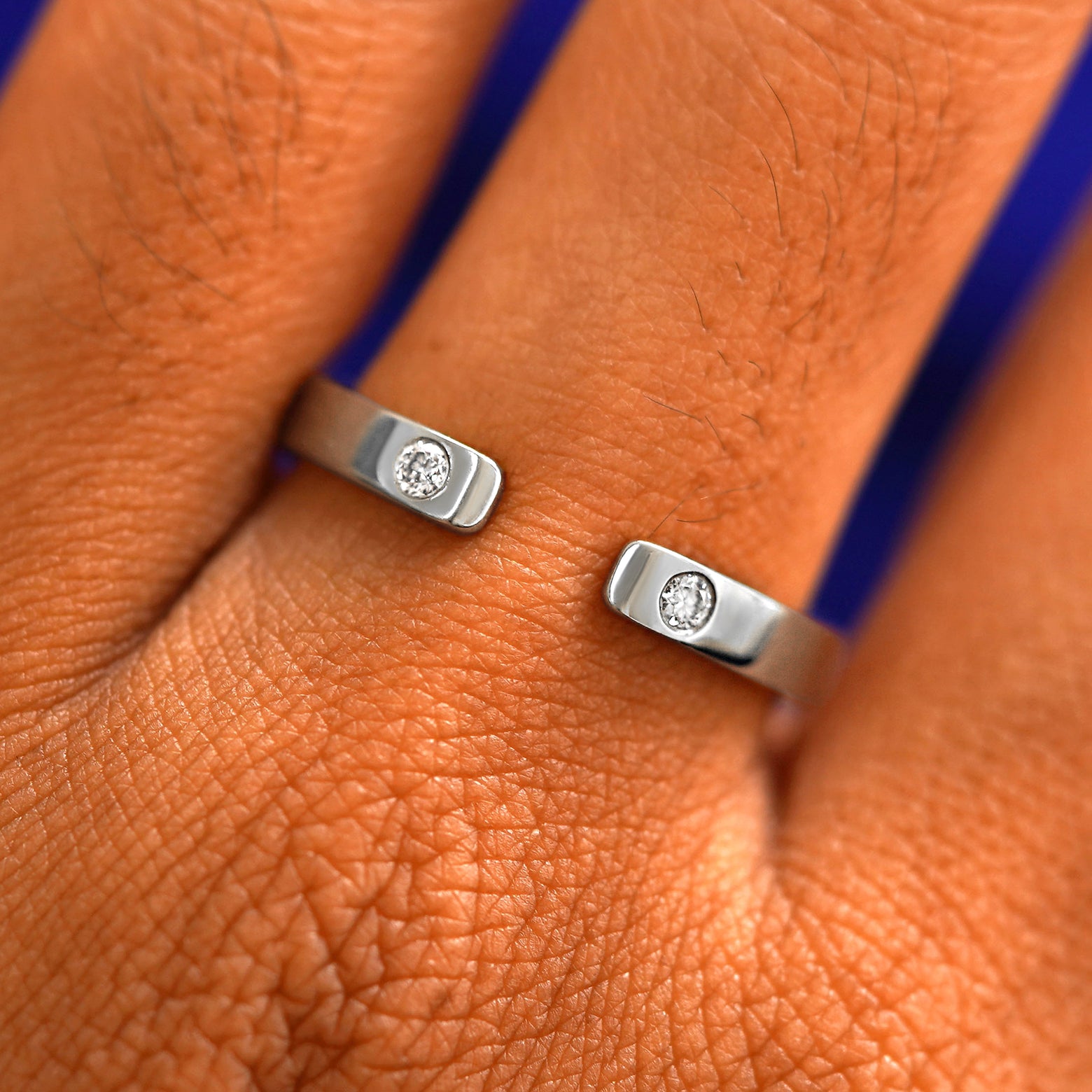 Close up view of a model's fingers wearing a 14k white gold Open Industrial Band