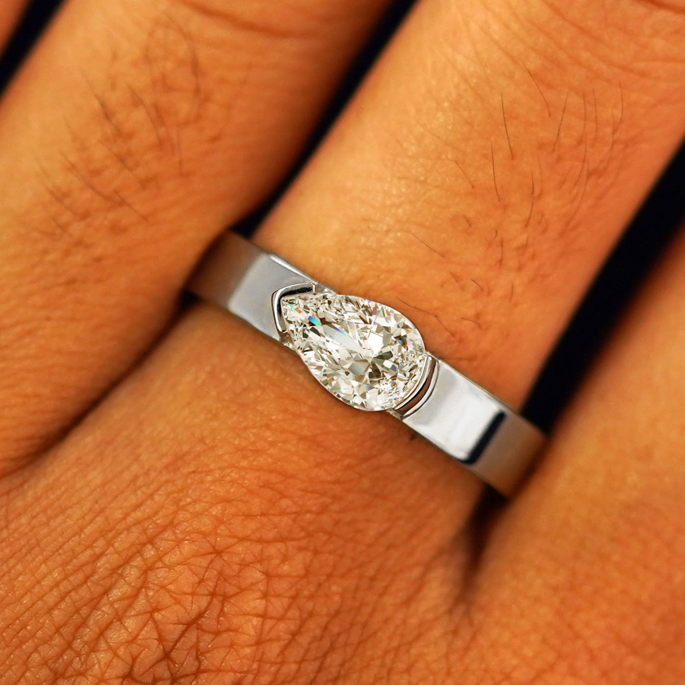 Close up view of a model's fingers wearing a 14k white gold Lab Diamond Pear Ring