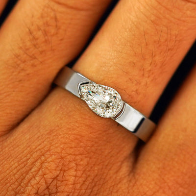Close up view of a model's fingers wearing a 14k white gold Lab Diamond Pear Ring