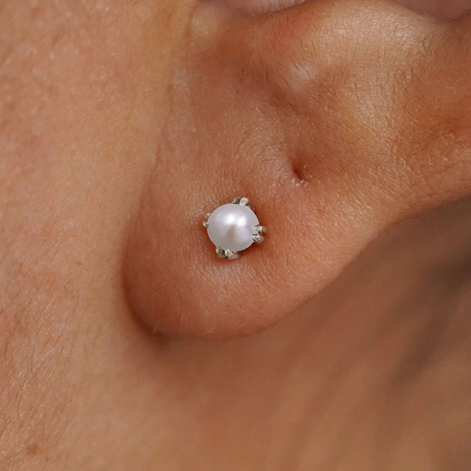 Close up view of a model's ear wearing a 14k white gold Citrine Stud Earring